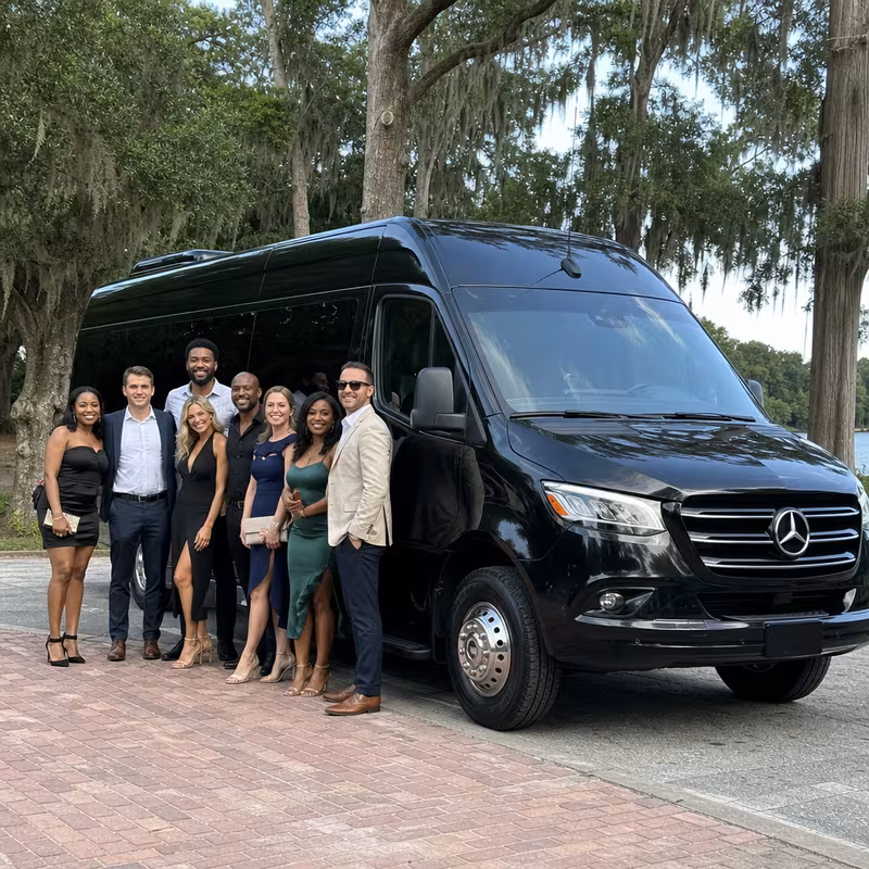 Group beside a Mercedes Sprinter limo from the Tallahassee fleet