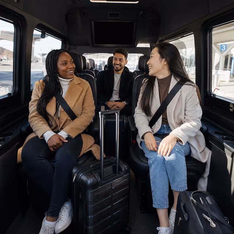 Passengers loading luggage while boarding an Tallahassee group shuttle
