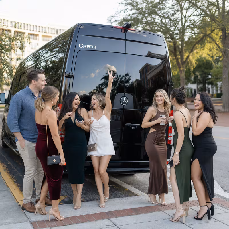Group boarding a white charter bus for Bachelor & Bachelorette Transportation transportation in Tallahassee