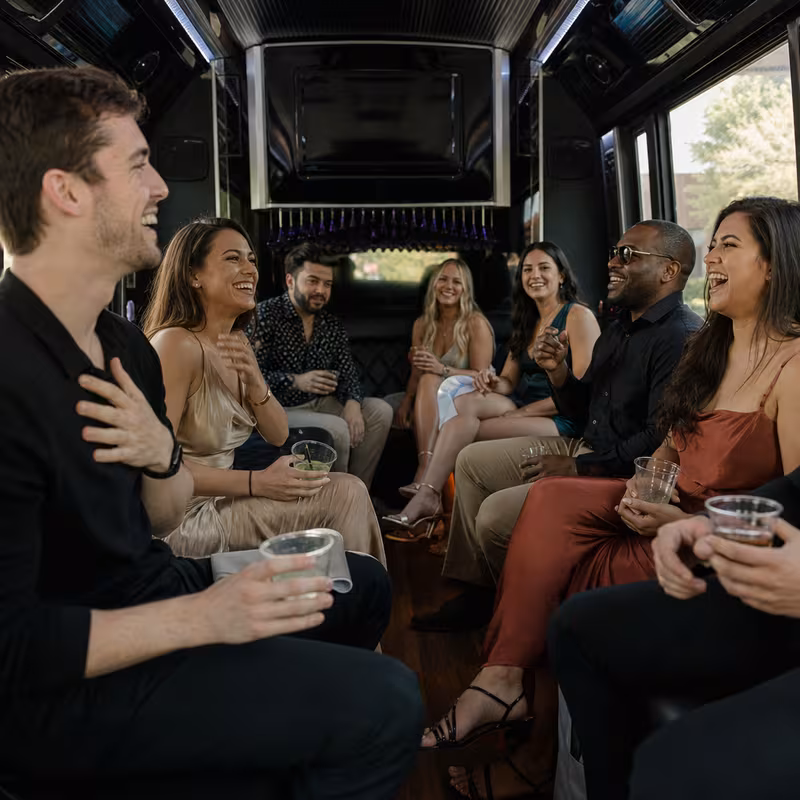 Party bus interior with wraparound leather seating and LED lighting in Tallahassee