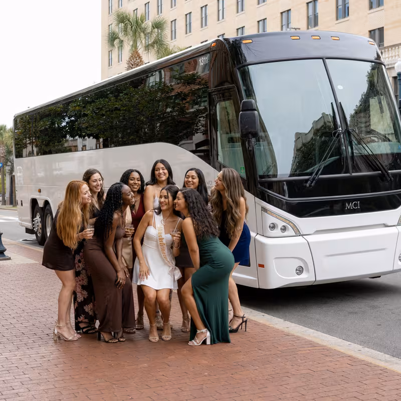 Passengers loading luggage while boarding an Tallahassee group shuttle