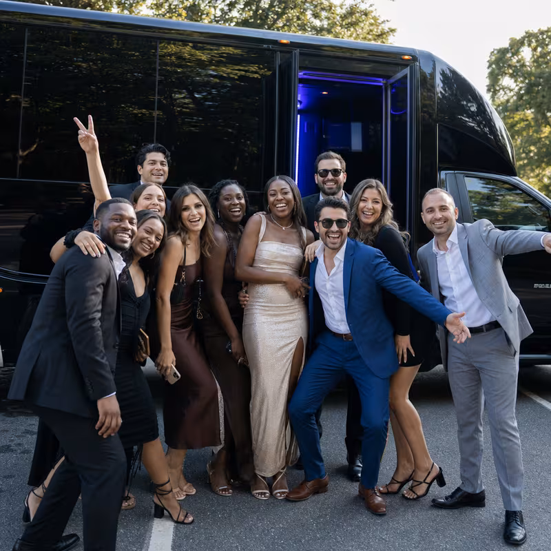Group boarding a white charter bus for Birthday Transportation transportation in Tallahassee