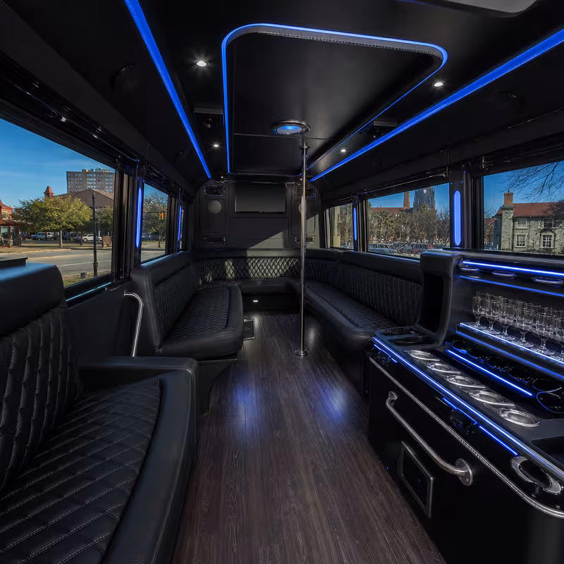 Party bus interior with wraparound leather seating and LED lighting in Tallahassee