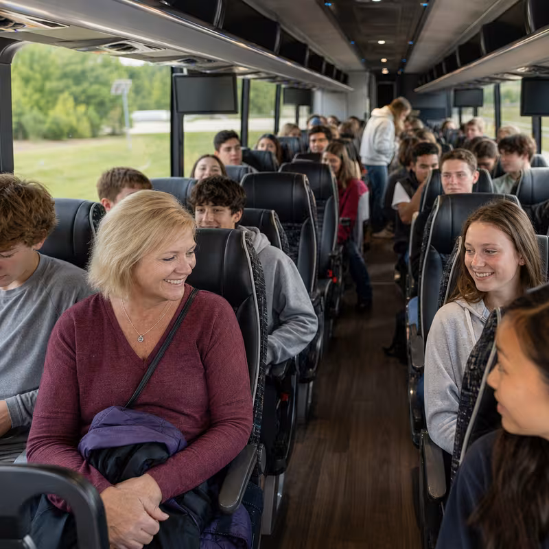 Group boarding a white charter bus for School Transportation transportation in Tallahassee