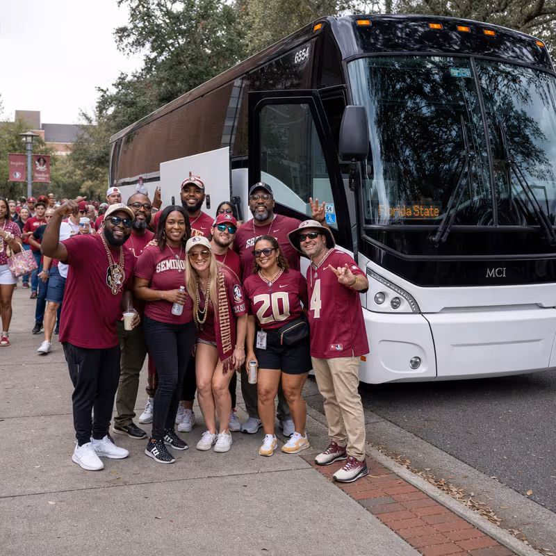 Passengers loading luggage while boarding an Tallahassee group shuttle