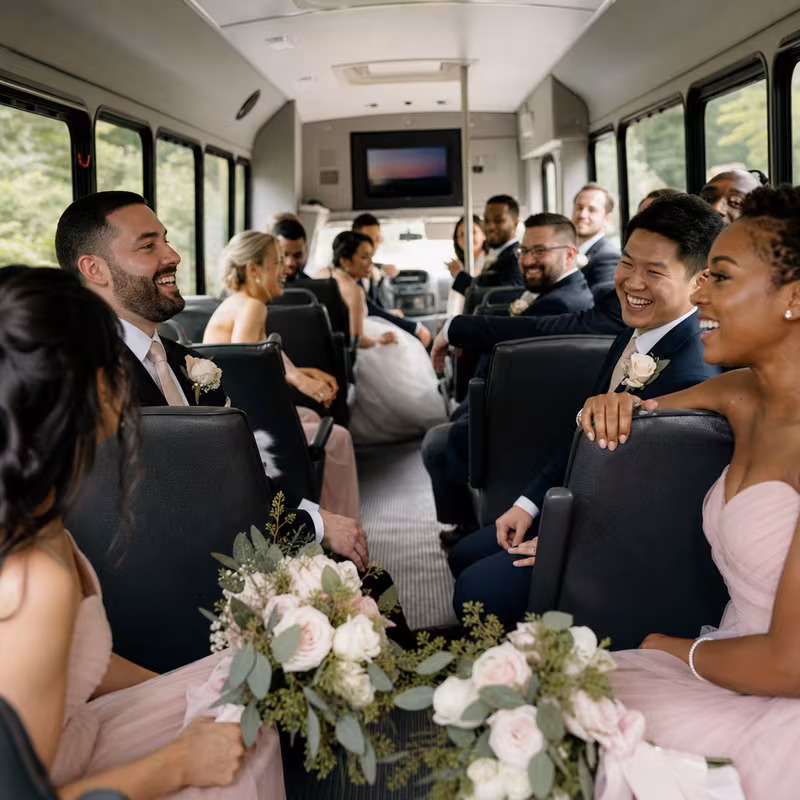 Group boarding a white charter bus for Wedding Transportation transportation in Tallahassee