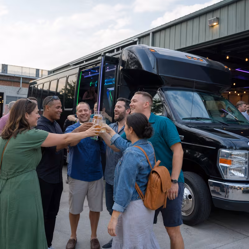 Passengers loading luggage while boarding an Tallahassee group shuttle